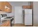 View of kitchen with gas range, granite counters, and white appliances at 6742 Gold Yarrow St, Las Vegas, NV 89148