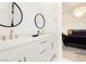 Double vanity bathroom with gold fixtures and a view into bedroom at 818 Meyer May St, Las Vegas, NV 89138