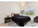 Guest bedroom with patterned wallpaper and a comfortable bed at 818 Meyer May St, Las Vegas, NV 89138