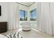 Bright bedroom with large windows, plush seating, and pool view at 818 Meyer May St, Las Vegas, NV 89138