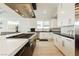 Bright kitchen featuring white cabinets, gas cooktop, and herringbone backsplash at 818 Meyer May St, Las Vegas, NV 89138