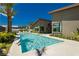 Luxury pool with lounge chairs, landscaping, and a modern home at 818 Meyer May St, Las Vegas, NV 89138
