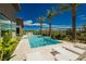 Modern rectangular pool with lounge chairs and outdoor grill at 818 Meyer May St, Las Vegas, NV 89138