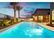 Luxury pool with spa, landscaping, and a modern home in the background at 818 Meyer May St, Las Vegas, NV 89138