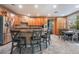 Kitchen with an island, wood cabinetry, and tile flooring at 8224 Chimney Bluffs St, North Las Vegas, NV 89085