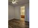 Bedroom with wood-look flooring and bathroom access at 9007 Purple Leaf St, Las Vegas, NV 89123