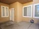 Small front patio with a white door and two windows at 9007 Purple Leaf St, Las Vegas, NV 89123