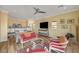 Main bedroom with seating area, large TV and ceiling fan at 943 Woodacre Dr, Boulder City, NV 89005