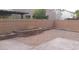 Landscaped backyard with a stone planter and patio at 10371 Calypso Cave St, Las Vegas, NV 89141