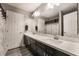 Bathroom features double sinks, an expansive mirror, and dark wood cabinets at 10529 Parthenon St, Las Vegas, NV 89183