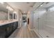 Bathroom showcases a large, frameless glass shower and double vanity with modern fixtures at 10529 Parthenon St, Las Vegas, NV 89183