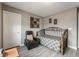 Guest bedroom with daybed, recliner, and gray and white bedding at 10529 Parthenon St, Las Vegas, NV 89183