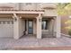 Close-up of the entrance of a two-story home featuring columns and a brick driveway at 10529 Parthenon St, Las Vegas, NV 89183