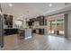 Modern kitchen with stainless steel appliances, an island, and dark wood cabinets at 10529 Parthenon St, Las Vegas, NV 89183