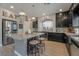 Spacious kitchen featuring an island with seating and modern stainless steel appliances at 10529 Parthenon St, Las Vegas, NV 89183