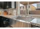 Modern farmhouse sink with a sleek faucet and granite countertops at 10529 Parthenon St, Las Vegas, NV 89183