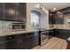 Kitchen boasts granite countertops, stainless steel appliances, and dark cabinetry at 10529 Parthenon St, Las Vegas, NV 89183