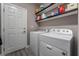 Laundry room with washer, dryer, and built-in shelving at 10529 Parthenon St, Las Vegas, NV 89183