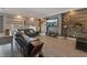 Living room featuring a large TV, wood-look floors, and modern decor at 10529 Parthenon St, Las Vegas, NV 89183