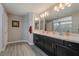 Main bathroom with double vanity and dark wood cabinets at 10529 Parthenon St, Las Vegas, NV 89183