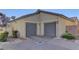 Two-car garage with gray doors and ample driveway space at 1067 Garden Cress Ct, Las Vegas, NV 89138