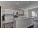 Modern kitchen with white cabinets and large island at 1067 Garden Cress Ct, Las Vegas, NV 89138