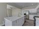 Modern kitchen with white cabinets and large island at 1067 Garden Cress Ct, Las Vegas, NV 89138