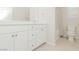 Clean bathroom with white vanity, tub shower, and toilet at 10718 Glowing Dawn Ave, Las Vegas, NV 89135