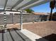 Backyard with covered patio and block wall at 118 Queenswreath Dr, North Las Vegas, NV 89031