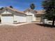 One-story house with attached garage and desert landscaping at 118 Queenswreath Dr, North Las Vegas, NV 89031