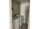 Laundry room with washer, dryer, and extra storage shelving at 118 Queenswreath Dr, North Las Vegas, NV 89031