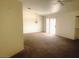 Bright living room with carpeted floors and sliding glass door at 118 Queenswreath Dr, North Las Vegas, NV 89031