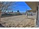 Large backyard with covered patio and view of neighboring homes at 1605 Oakwood Ave, North Las Vegas, NV 89030