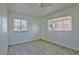 Well-lit bedroom featuring tile floors and two windows at 1605 Oakwood Ave, North Las Vegas, NV 89030