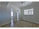 Well-lit bedroom featuring tile floors and a mirrored closet at 1605 Oakwood Ave, North Las Vegas, NV 89030