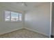 Simple bedroom with tile floors and a large window at 1605 Oakwood Ave, North Las Vegas, NV 89030