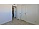 Bedroom with tile floors, double doors to closet, and bathroom access at 1605 Oakwood Ave, North Las Vegas, NV 89030