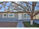 Front view of a single story home with tree at 1605 Oakwood Ave, North Las Vegas, NV 89030