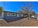 Single story house with gray exterior and gravel yard at 1605 Oakwood Ave, North Las Vegas, NV 89030