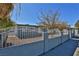 Gray house with white fence and nicely landscaped yard at 1605 Oakwood Ave, North Las Vegas, NV 89030