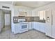 Updated kitchen featuring white cabinets, tile backsplash, and stainless steel appliances at 1605 Oakwood Ave, North Las Vegas, NV 89030