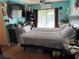 Primary bedroom with a large bed and teal walls at 2180 Palora Ave, Las Vegas, NV 89169