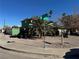 Green two-story house with a street view, showing the front yard and landscaping at 2180 Palora Ave, Las Vegas, NV 89169