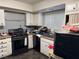 Kitchen with white cabinets and black appliances at 2180 Palora Ave, Las Vegas, NV 89169