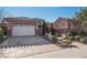 Single-story home with a two-car garage and manicured landscaping at 2261 Boutique Ave, Henderson, NV 89044