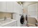 Bright laundry room with white cabinets and modern appliances at 2261 Boutique Ave, Henderson, NV 89044