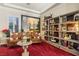 Cozy library with leather armchairs, built-in shelving, and large artwork at 2261 Boutique Ave, Henderson, NV 89044