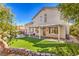 House exterior showcasing a covered patio, artificial turf, and a pool at 2374 Thayer Ave, Henderson, NV 89074