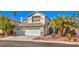 Home with a three-car garage and low maintenance desert landscaping at 2374 Thayer Ave, Henderson, NV 89074