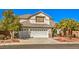 Home with a three-car garage and low maintenance desert landscaping at 2374 Thayer Ave, Henderson, NV 89074